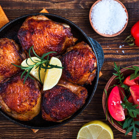Roasted chicken thighs with lemon and tomato salad