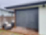 Grey slatted patio screen Nudgee on a ground level wooden deck.