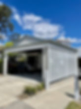 White slatted screen installed  on the side of a garage.