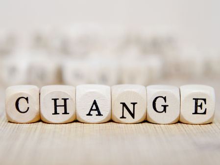 Wooden blocks spelling "CHANGE" on a light wooden surface, creating an atmosphere of transformation and new beginnings.