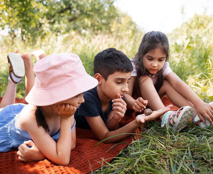 kids-spending-time-together-outdoors-blanket-enjoying-childhood.jpg
