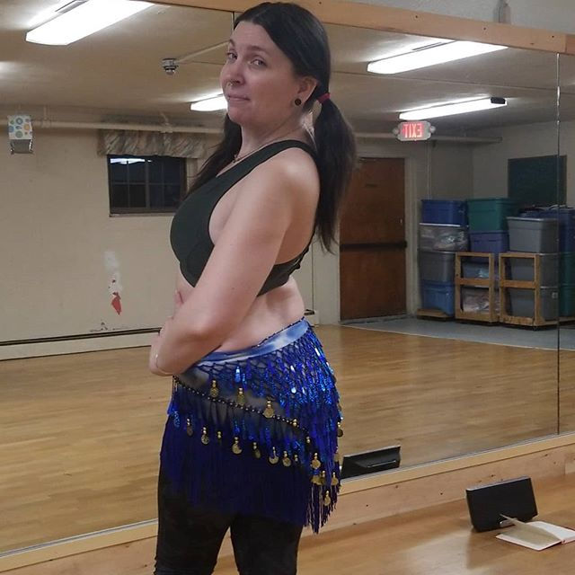 Dancer, Kisaya Rayne, wearing a sparkly blue hip scarf
