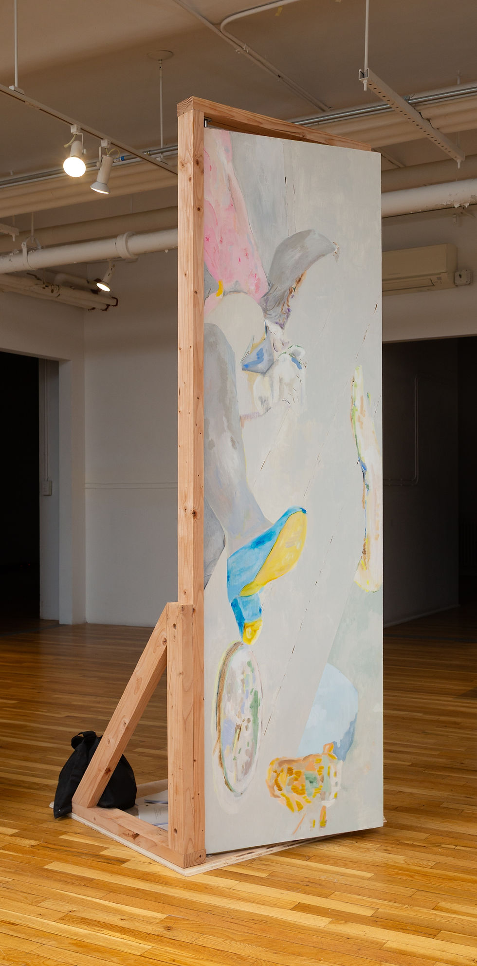 Delusions of a Swinging Door, 2025. Oil paint, acrylic paint, imitation silver leaf, swinging door hardware, pine, bolts, screws, salvaged door from the Roy Lichtenstein Foundation, sandbags, 24 x 30 x 84 inches.