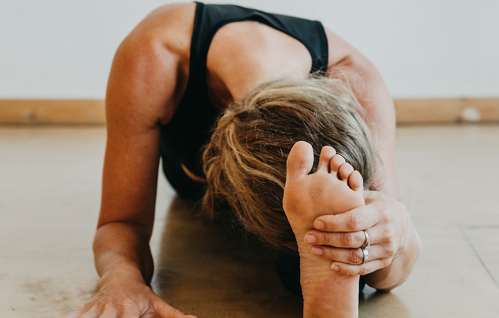 Student deepening forward fold during 200-hour yoga certification with Nieke Franken