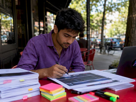 Trader studying printed trading terms at home desk