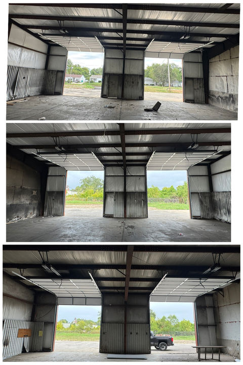 Empty industrial garage bays with open doors and metal framing. Premium Overhead Door LLC.