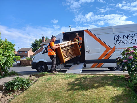 Two people loading the piano in the van