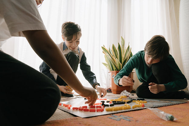 family playing a board game. kids pushing boundaries