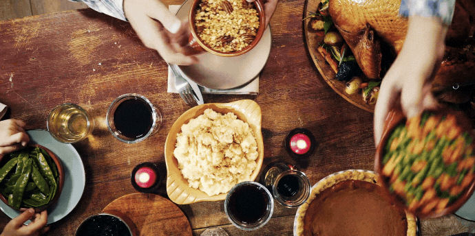 A gif or people passing food at the dinner table