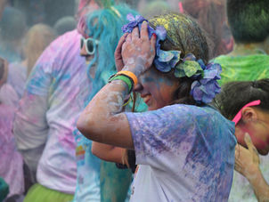 Runners getting sprayed with paint colors