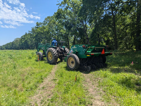 Seed drill installing seed at restoration site