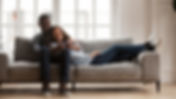 Happy mixed race couple relax on couch i