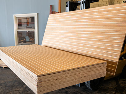 Stacks of teak and holly cabin sole plywood panels with traditional U.S.-style spacing, commonly used in yacht interiors, sailboats, and marine flooring applications.