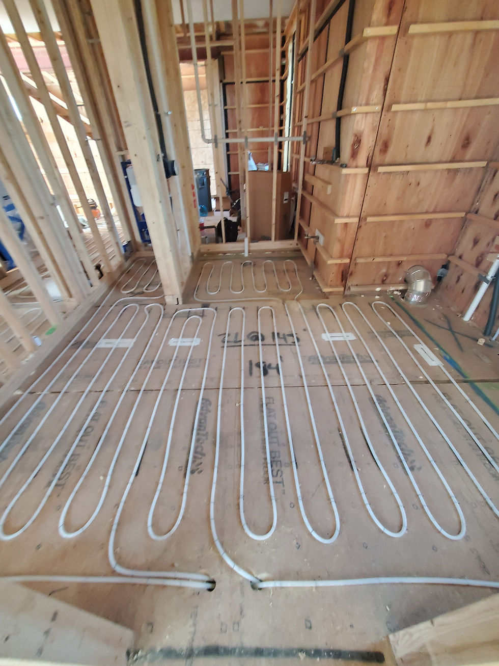 Radiant floor tubing laid out before finish flooring