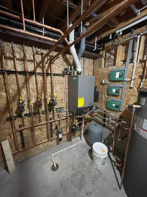 Wall-hung boiler, zone controls and copper near-boiler piping in a Denver-area mechanical room