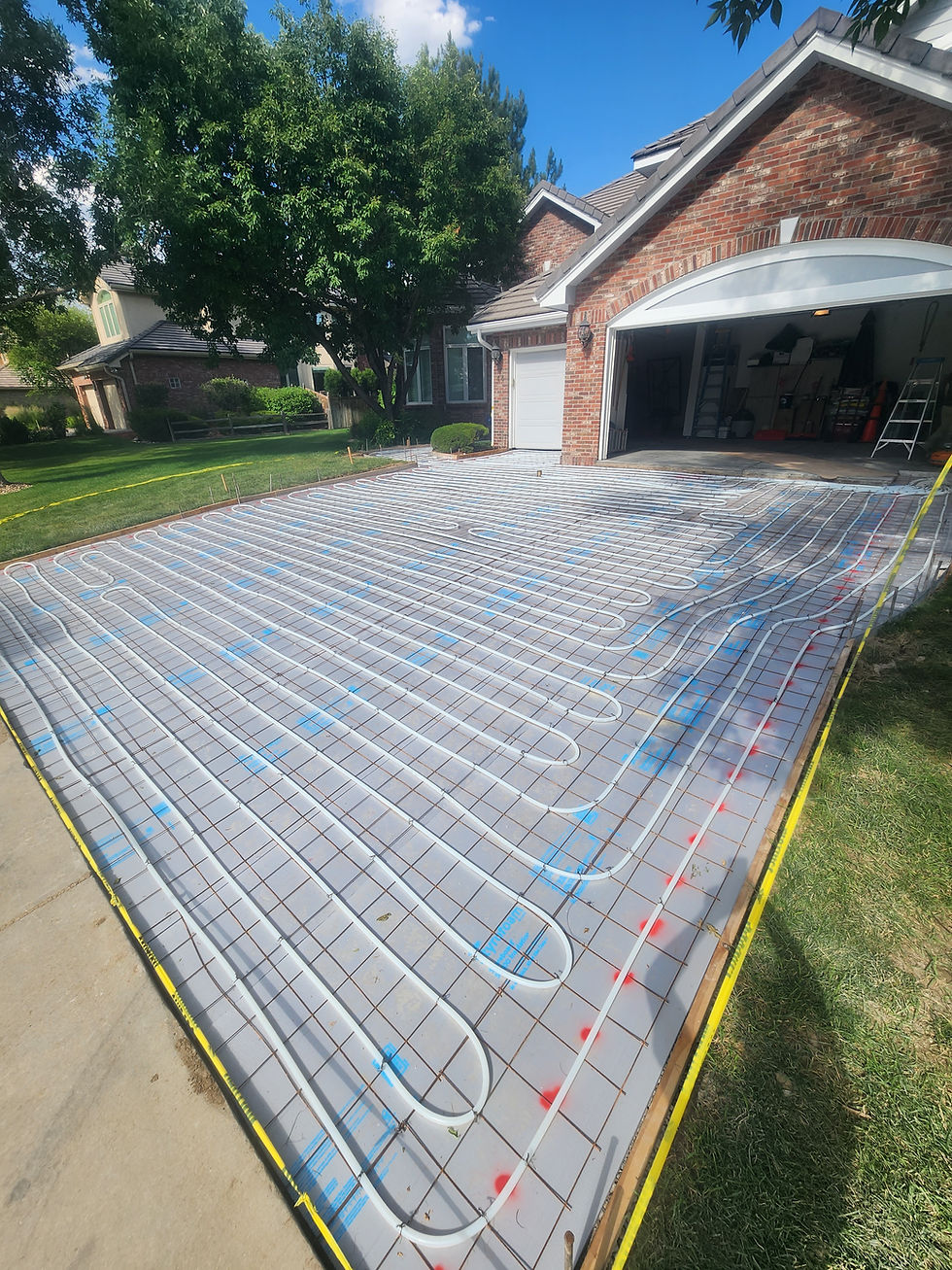 Residential driveway snowmelt system, PEX tubing tied to wire mesh before the concrete pour