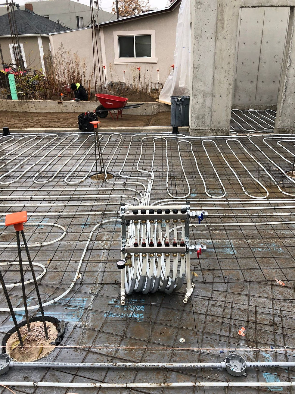 Radiant floor heating tubing tied off over slab insulation before a concrete pour