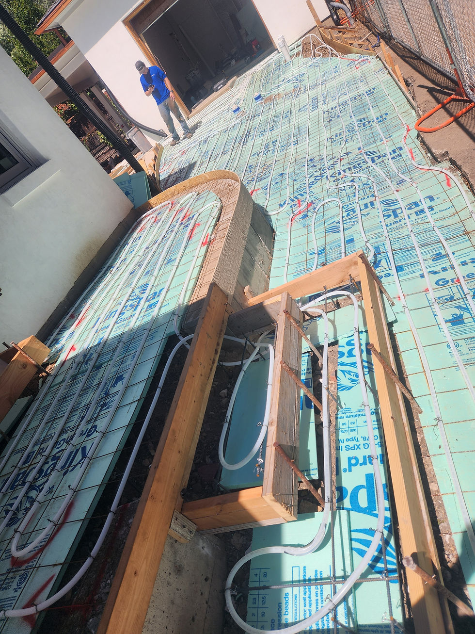 Snowmelt tubing on insulation panels across a patio deck