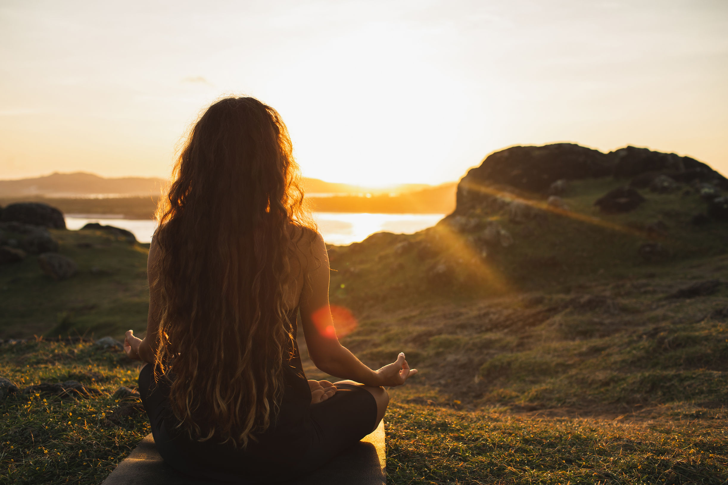 woman-meditating-yoga-alone-at-sunrise-mountains-2021-12-09-15-14-35-utc.jpg