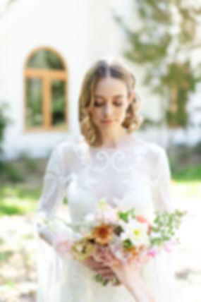 Luxury boho bride holding wedding bouquet in Santa Ynez, California.