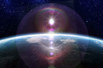 lens flare effect composited on the sun, rising behind the earth