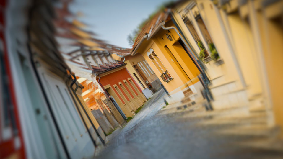 Trippy effect of a village street spiraling, twisting, and repeating