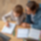 A high-quality, realistic photograph of a tutor teaching study skills to an elementary stu