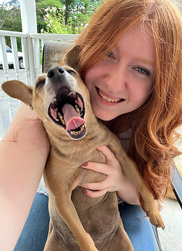 Picture of Heidi Weidenbenner, VP of Project Backpack. She is posing with her dog.