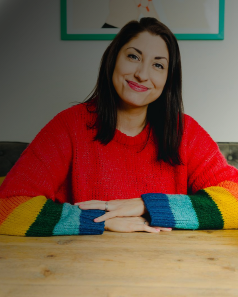 Smiling personal-brand portrait in a bright red jumper — website design for Jo Rennie Coaching.