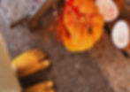 Barefeet with toe rings on concrete near a smashed pumpkin with red powder and coconut halves, next to a metal step. Pooja ritual at Salsa Samosa Bristol.