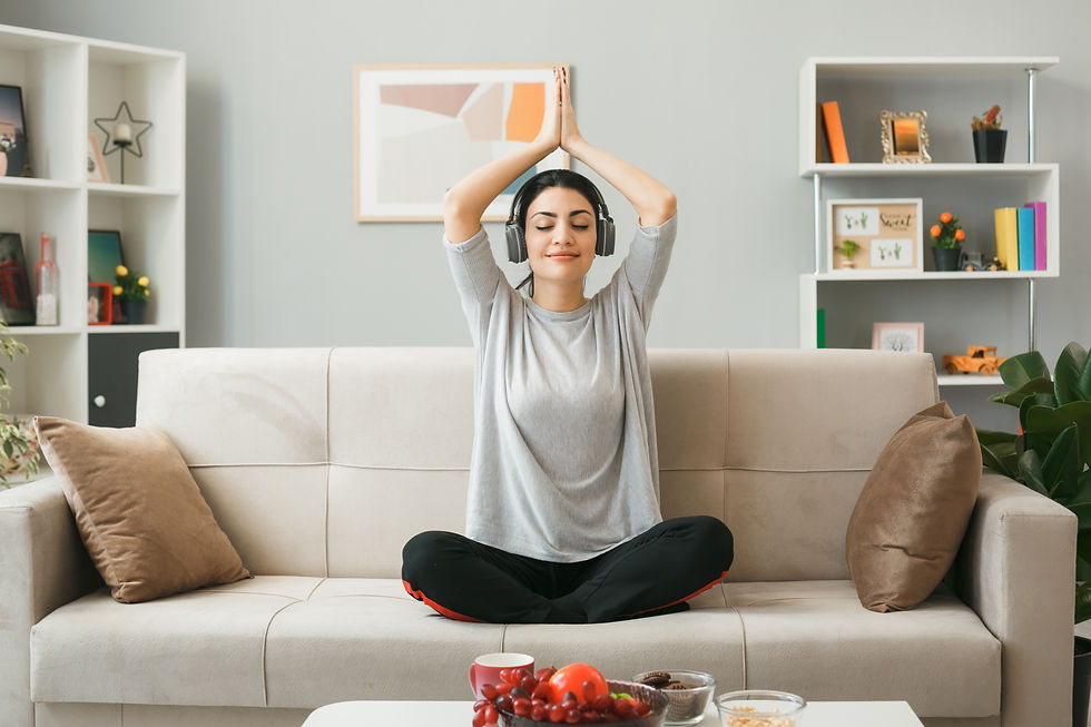pleased-young-girl-wearing-headphones-doing-yoga-sitting-sofa-coffee-table-living-room.jpg