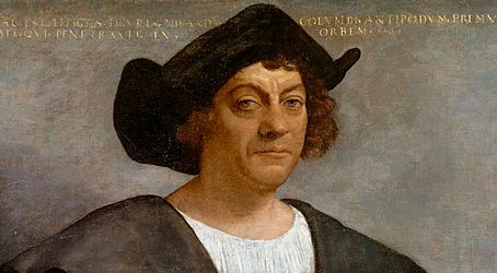 Posthumous portrait of a man said to be Christopher Columbus, by Sebastiano del Piombo, 1519. He is wearing a dark robe and black hat against a muted background. He is resting one hand on his chest, with text in the background.
