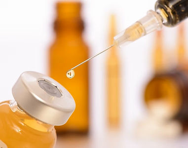 Vitamin vial and syringe prepared for an anti-age injection in NYC