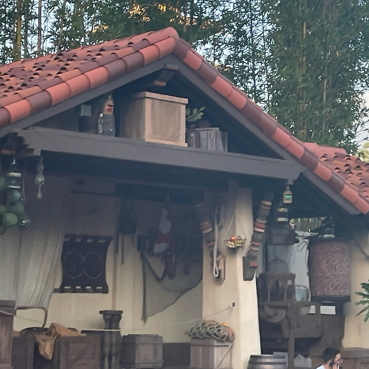 Captain Jack Sparrow meet and greet at Magic Kingdom, with nautical decor, barrels, setting the scene for swashbuckling selfies in Adventureland.