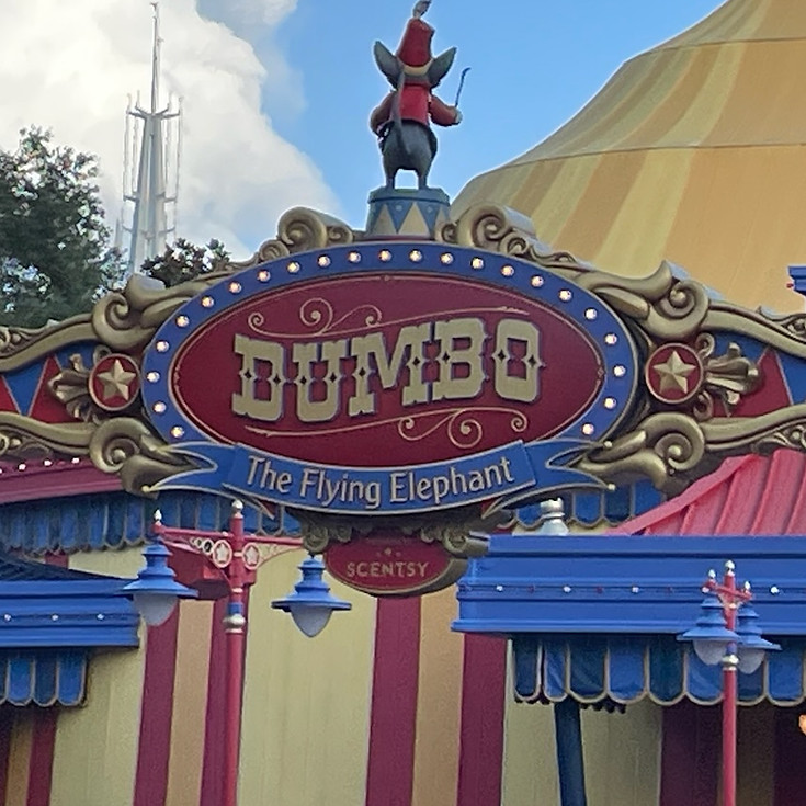 Entrance sign for Dumbo the Flying Elephant at Magic Kingdom, featuring colorful circus-themed design with bold lettering, festive, and whimsical details welcoming guests to the classic attraction.