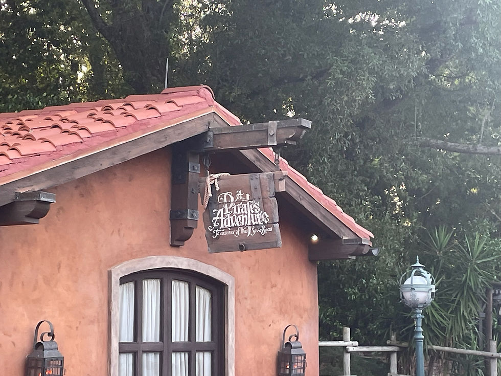 Pirate’s Adventure sign at Magic Kingdom, featuring weathered pirate lettering inviting guests on an interactive scavenger hunt in Adventureland.