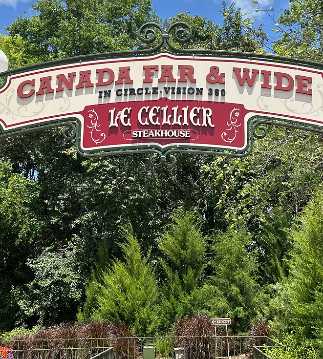 Canada Far and Wide in Circle-Vision 360 sign and entrance with lights and trees