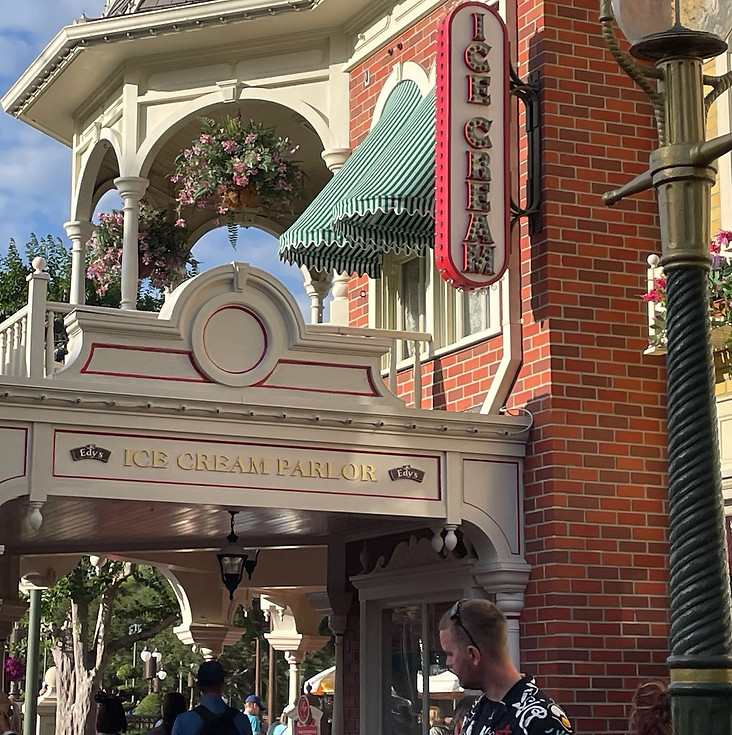 Plaza Ice Cream Parlor on Main Street U.S.A., with its vintage red-and-white design, gold signage.