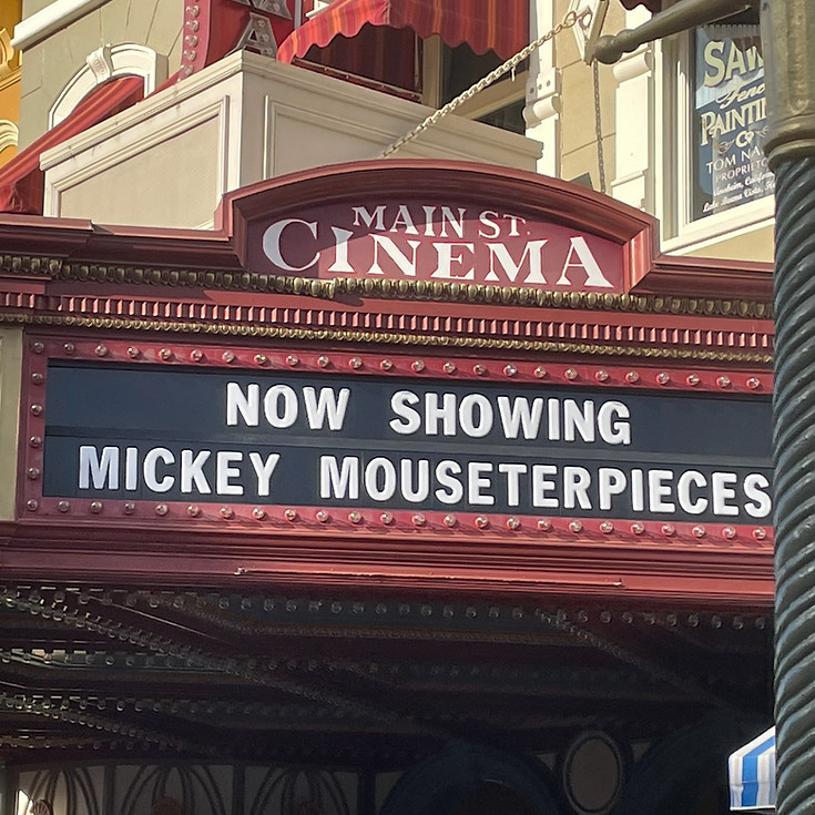 Main Street Cinema on Main Street U.S.A., a nostalgic storefront with classic film posters, red awnings, and vintage-style details.