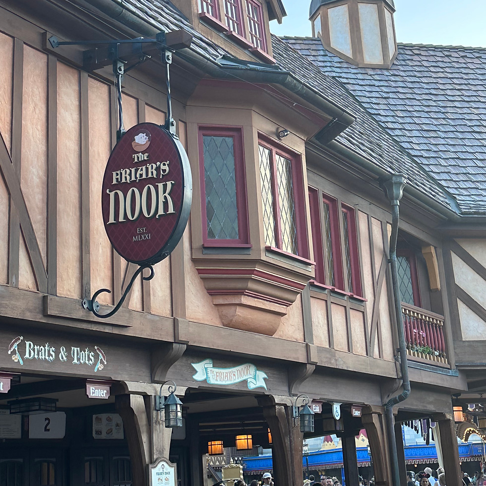 The Friar’s Nook in Fantasyland, a cozy medieval-style snack spot with a timbered roof, colorful banners, and charming village details.