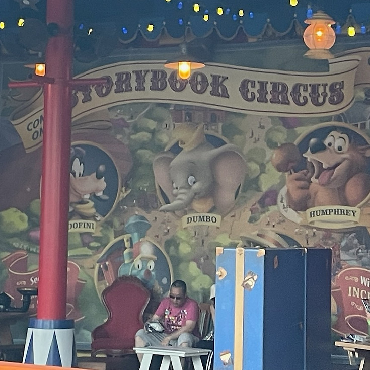 Meet and greet sign at Storybook Circus in Magic Kingdom featuring Goofy, Dumbo, and Humphrey the Bear, styled with vintage circus lettering and playful artwork above the striped tent entrance.