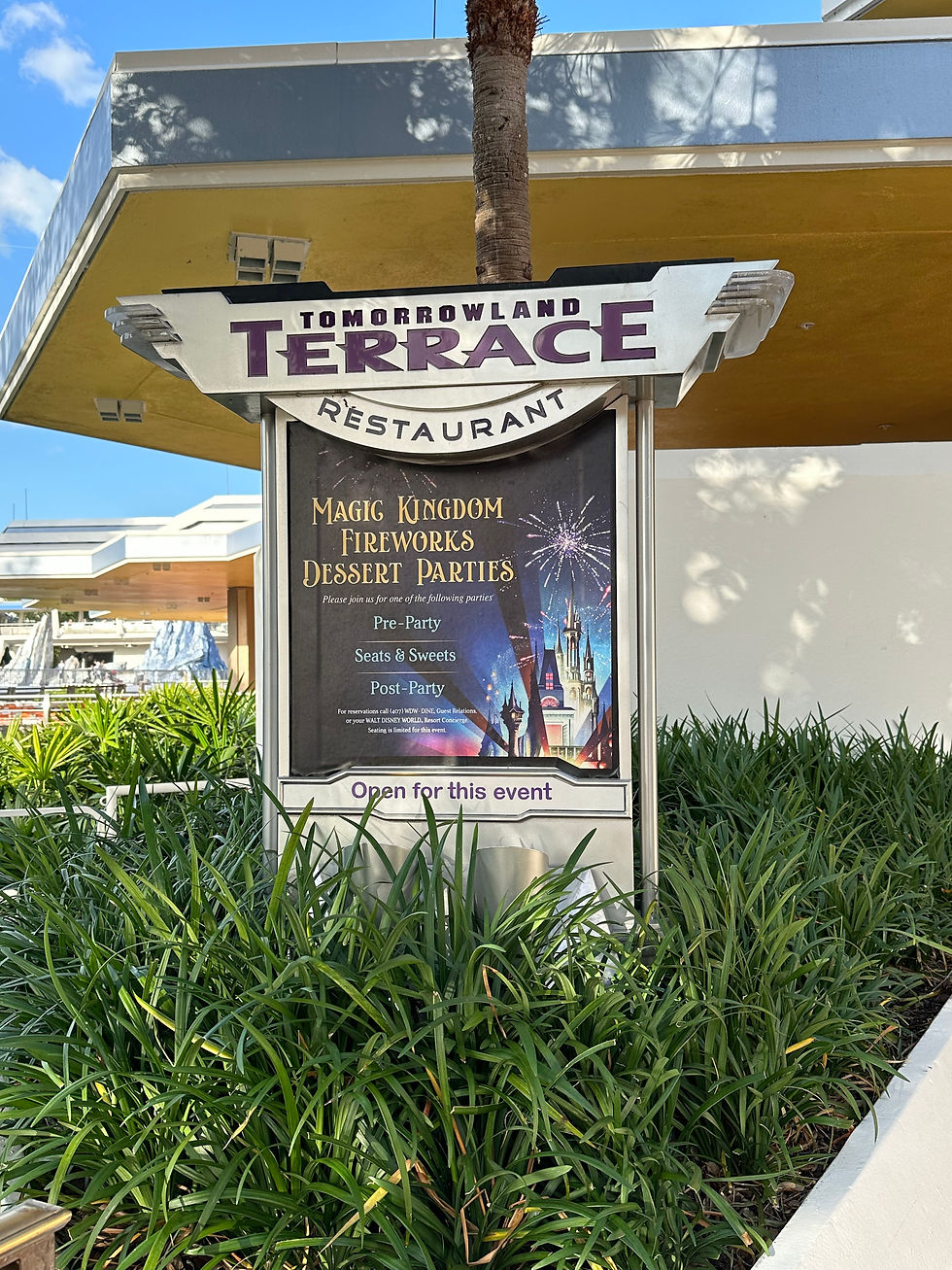 The Tomorrowland Terrace sign at Magic Kingdom, featuring sleek futuristic lettering and a metallic design that blends with the Tomorrowland theme.