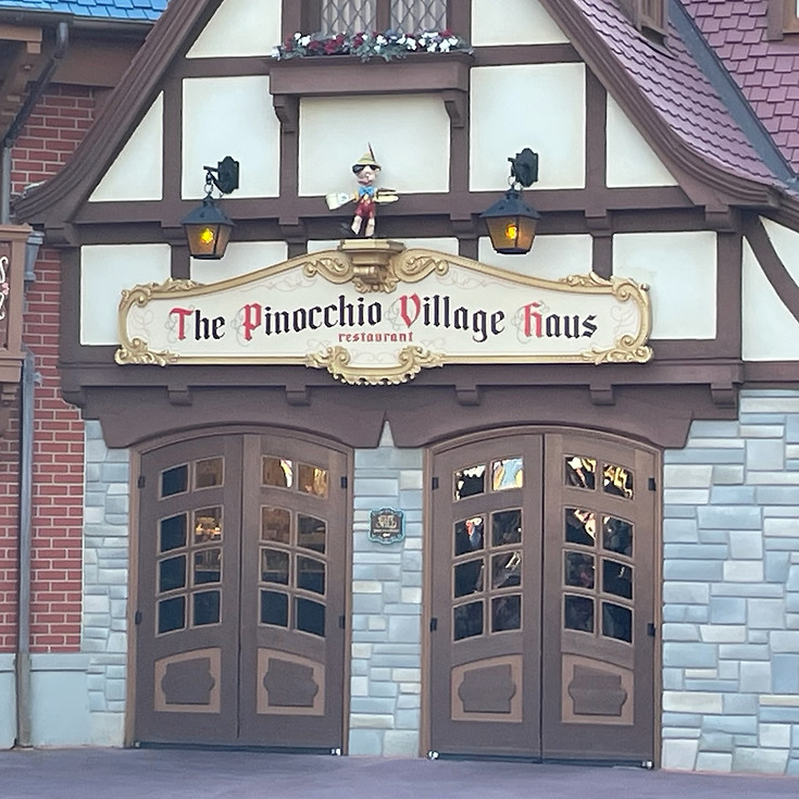 The storybook-style Pinocchio Village Haus in Fantasyland, with its timbered façade, and colorful window shutters.