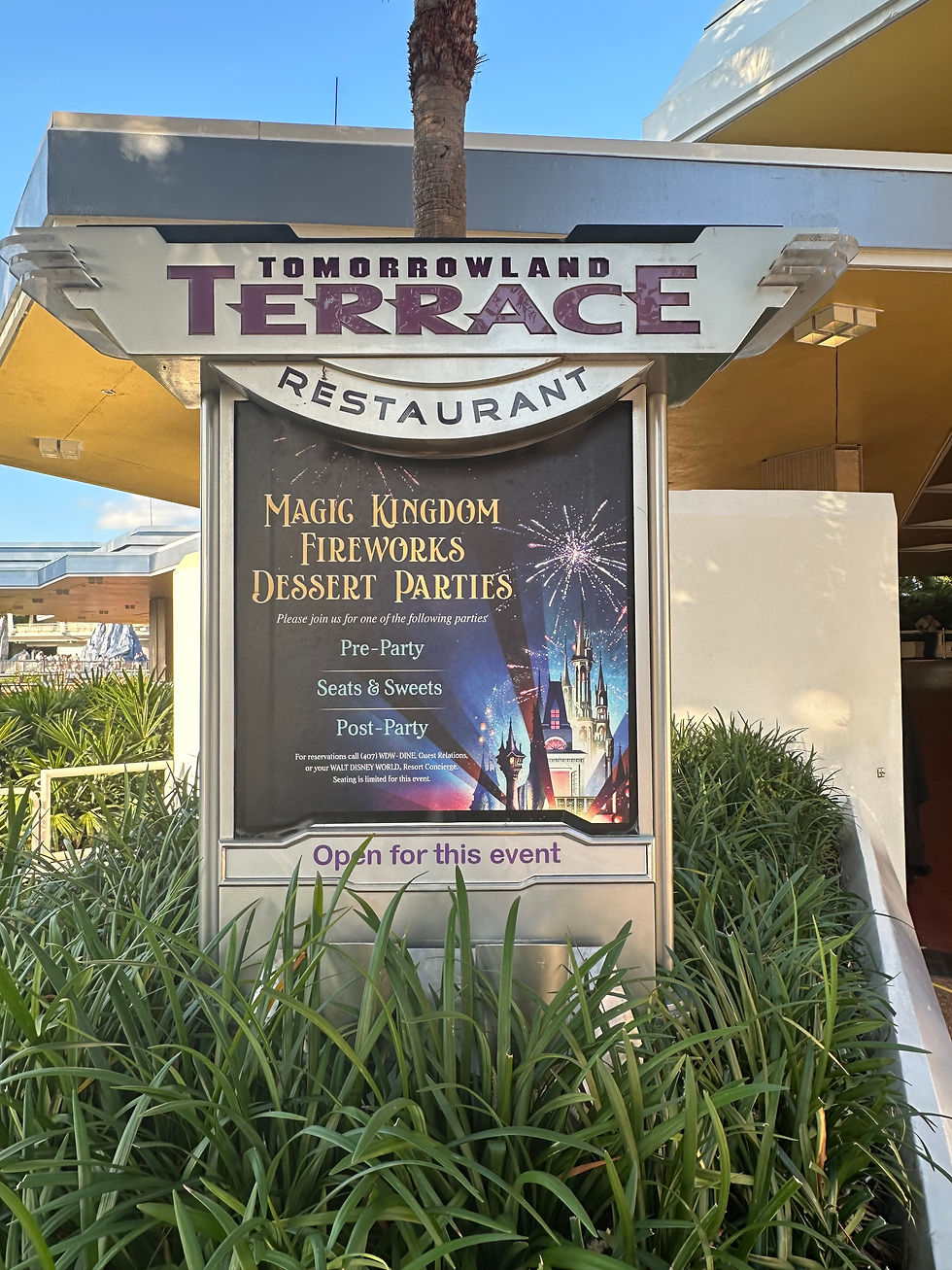 The Tomorrowland Terrace sign at Magic Kingdom, featuring sleek futuristic lettering and a metallic design that blends with the Tomorrowland theme.