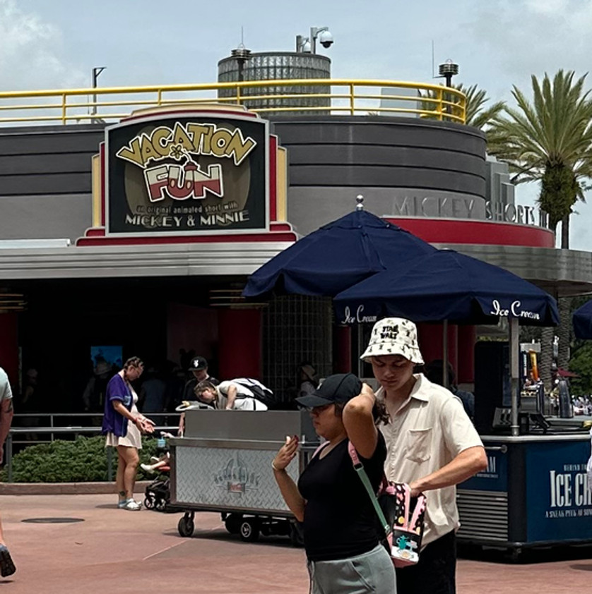 Colorful “Vacation Fun” sign in playful cartoon font above the entrance to the Mickey Shorts Theater.