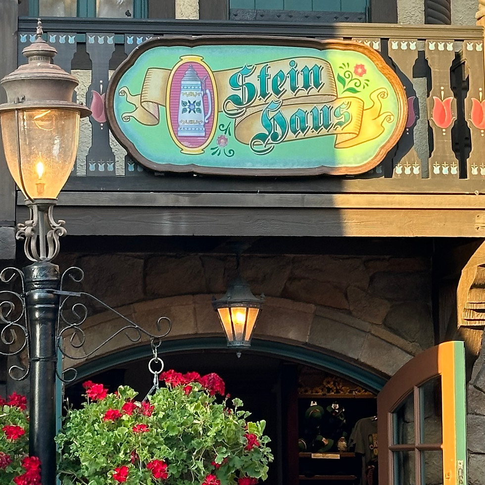 Stein Haus sign at EPCOT’s Germany Pavilion, on a timber-framed building with decorative shutters and Bavarian details.