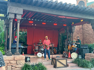 Band performing in front of a Moroccan style backdrop.