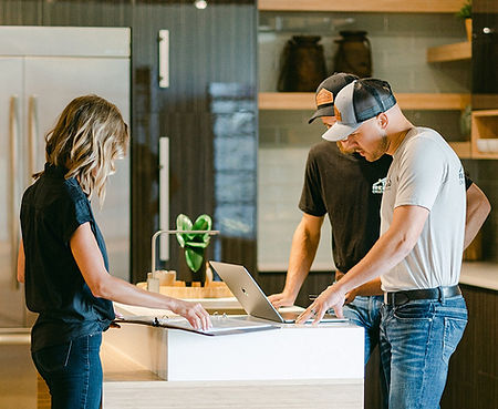 Renew Design+Build team reviews project details on-site in a kitchen remodel in Camas