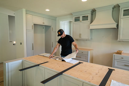 Josh Holmgren reviews plans in a Vancouver kitchen remodel project during construction