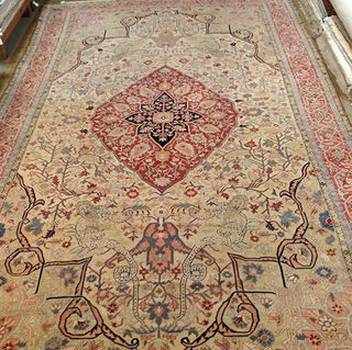 Persian Serapi 12-3x19-3 ca.1890 The light colored background and the lack of a lot of navy blue make it a very desirable rug. Also, there are four unusual creatures on the field of the rug.